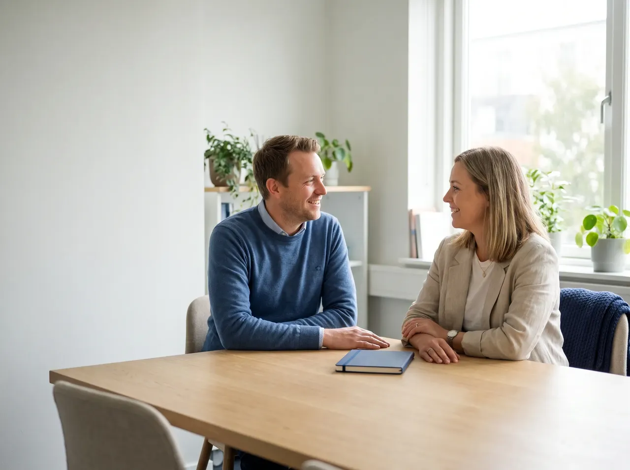 An HGC IT consultant talking through an IT review with a small business owner in a bright UK office